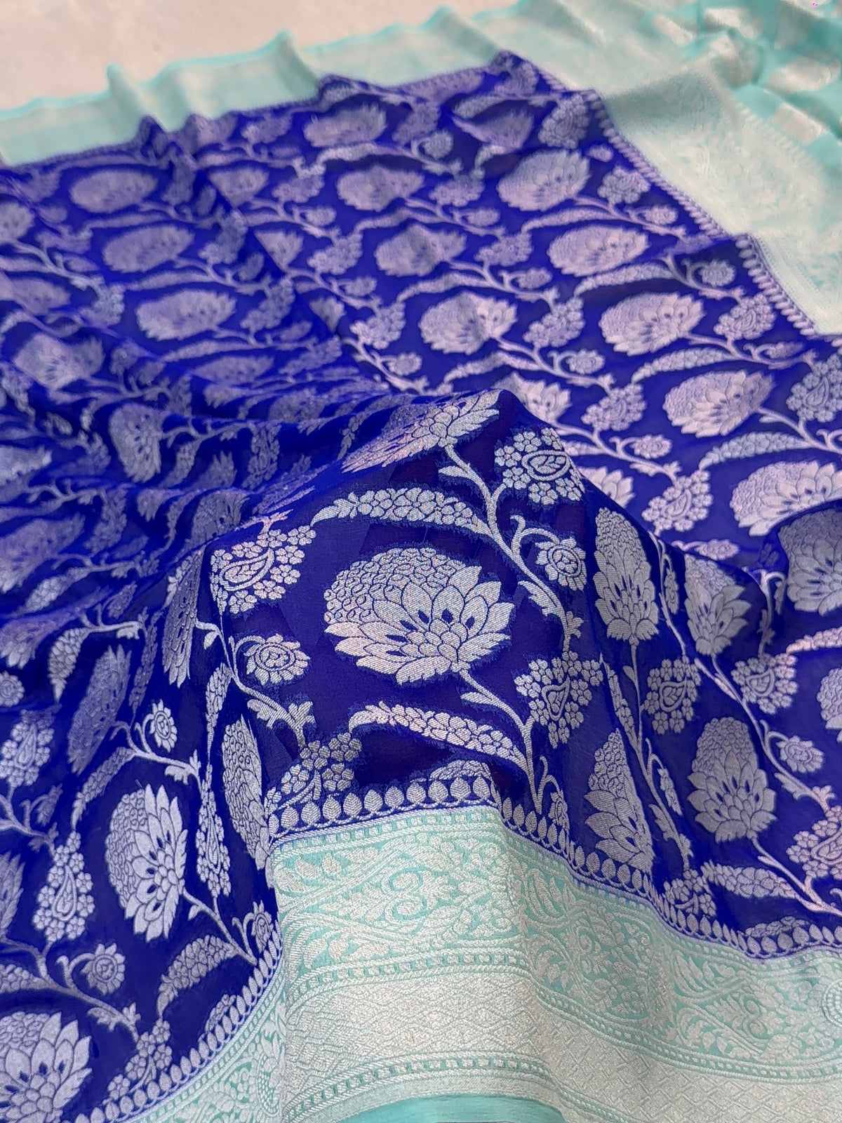 Banarasi Pure Khaddi Chiffon Saree  with Silver Zari Work In Floral Jaal Design in Royal Blue and Light Sea Green Colour Combination
