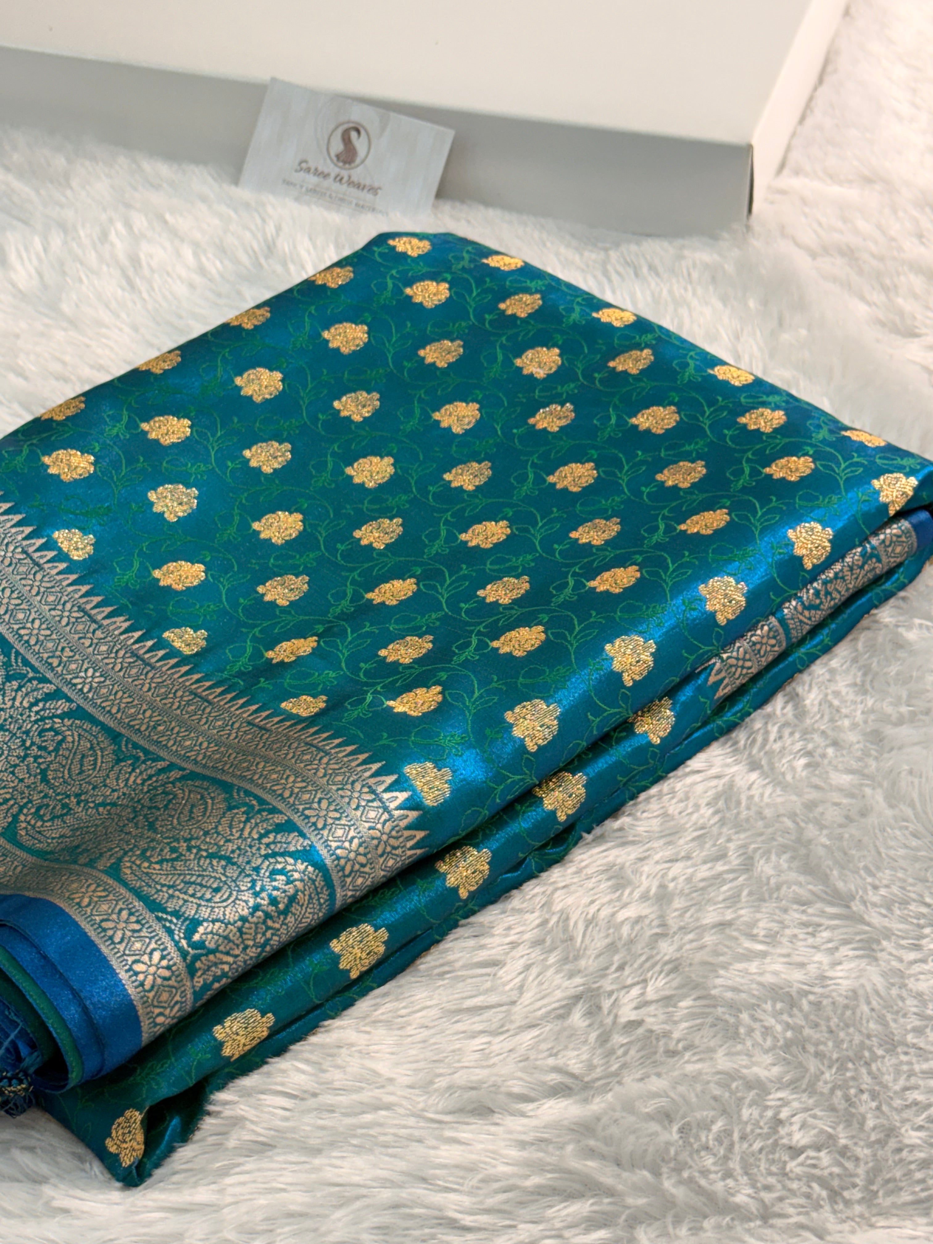 Banarasi satin silk saree in bottle green color with tanchoi design all over the body