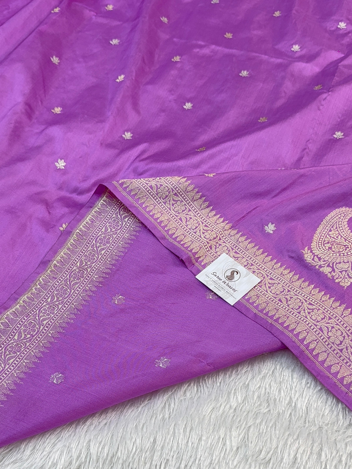 Handwoven pure katan silk saree with interlock weaving motifs and Konia design with intricate silver and gold zari in a light Purple colour
