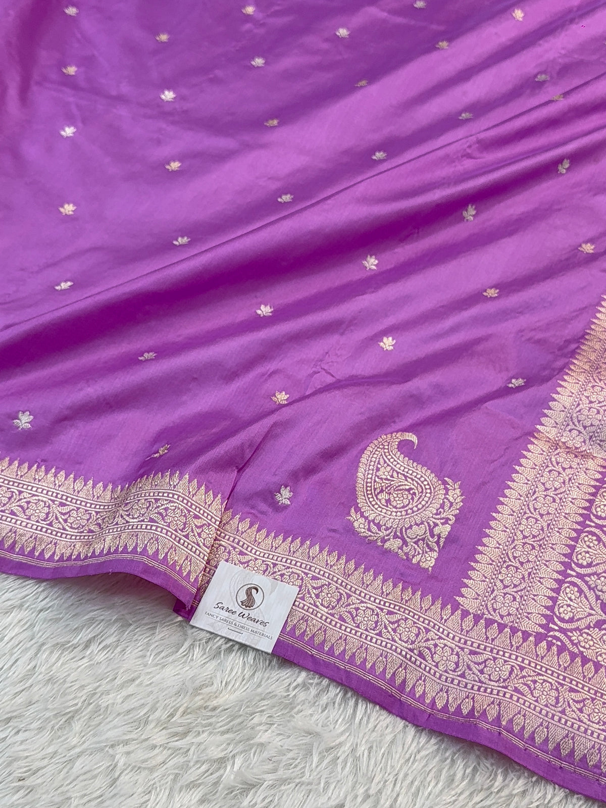 Handwoven pure katan silk saree with interlock weaving motifs and Konia design with intricate silver and gold zari in a light Purple colour