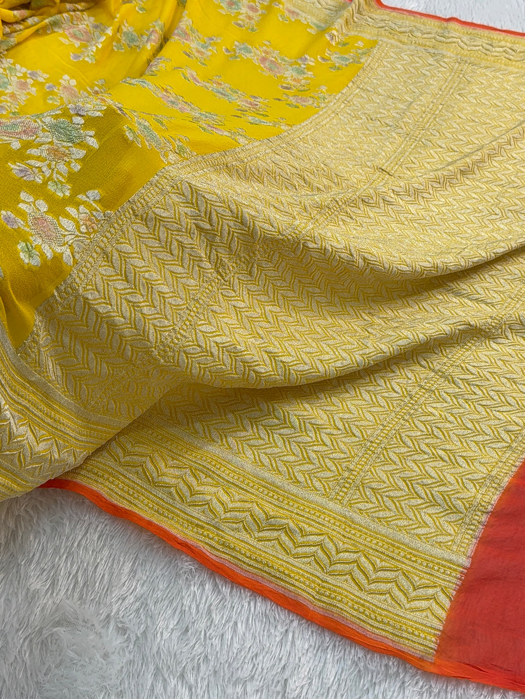 Banarasi Pure Khaddi Chiffon Saree  with Silver Zari Work In Floral Jaal Design with Meenakari by handbrush Yellow Colour with orange edge