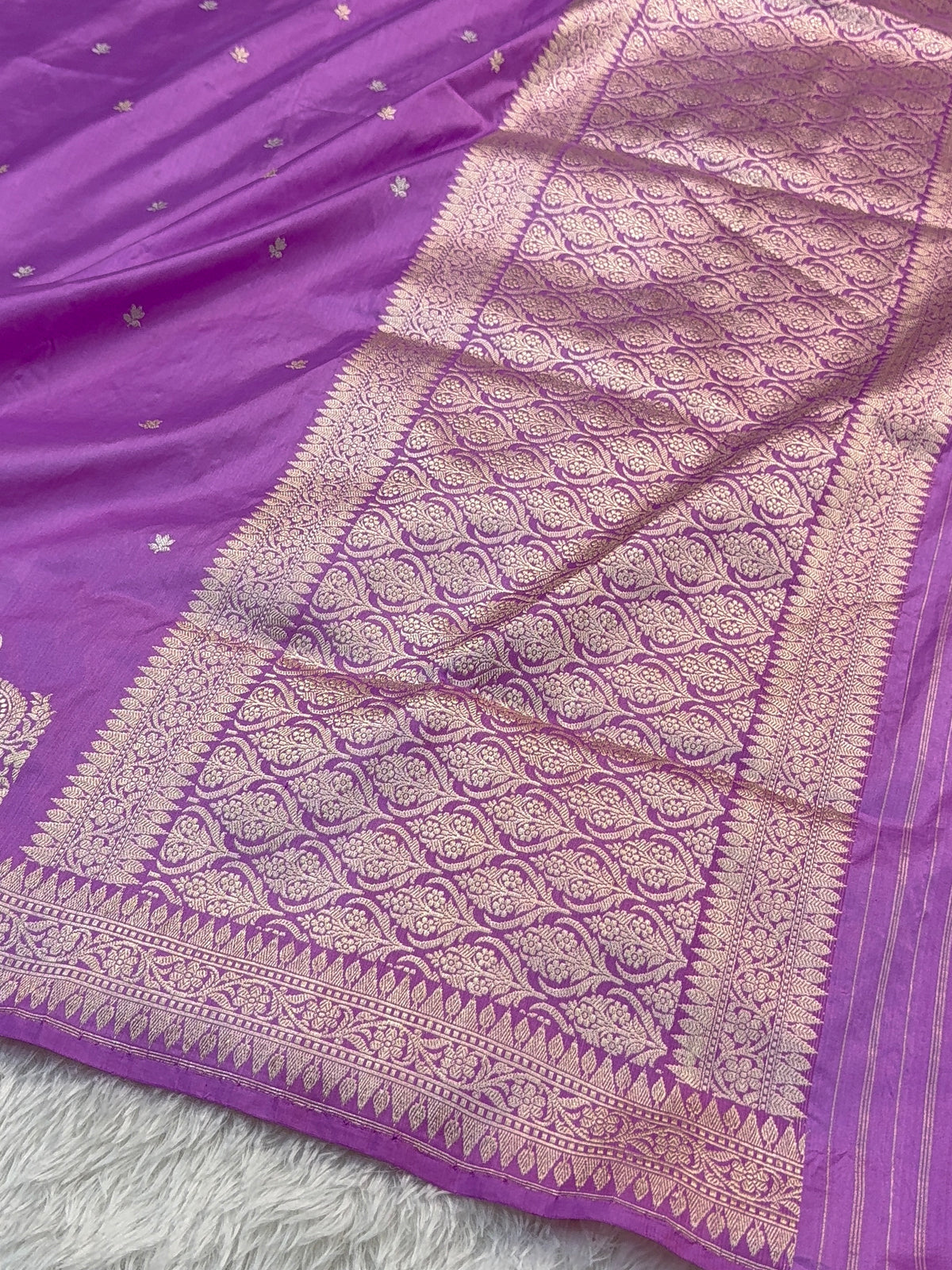Handwoven pure katan silk saree with interlock weaving motifs and Konia design with intricate silver and gold zari in a light Purple colour