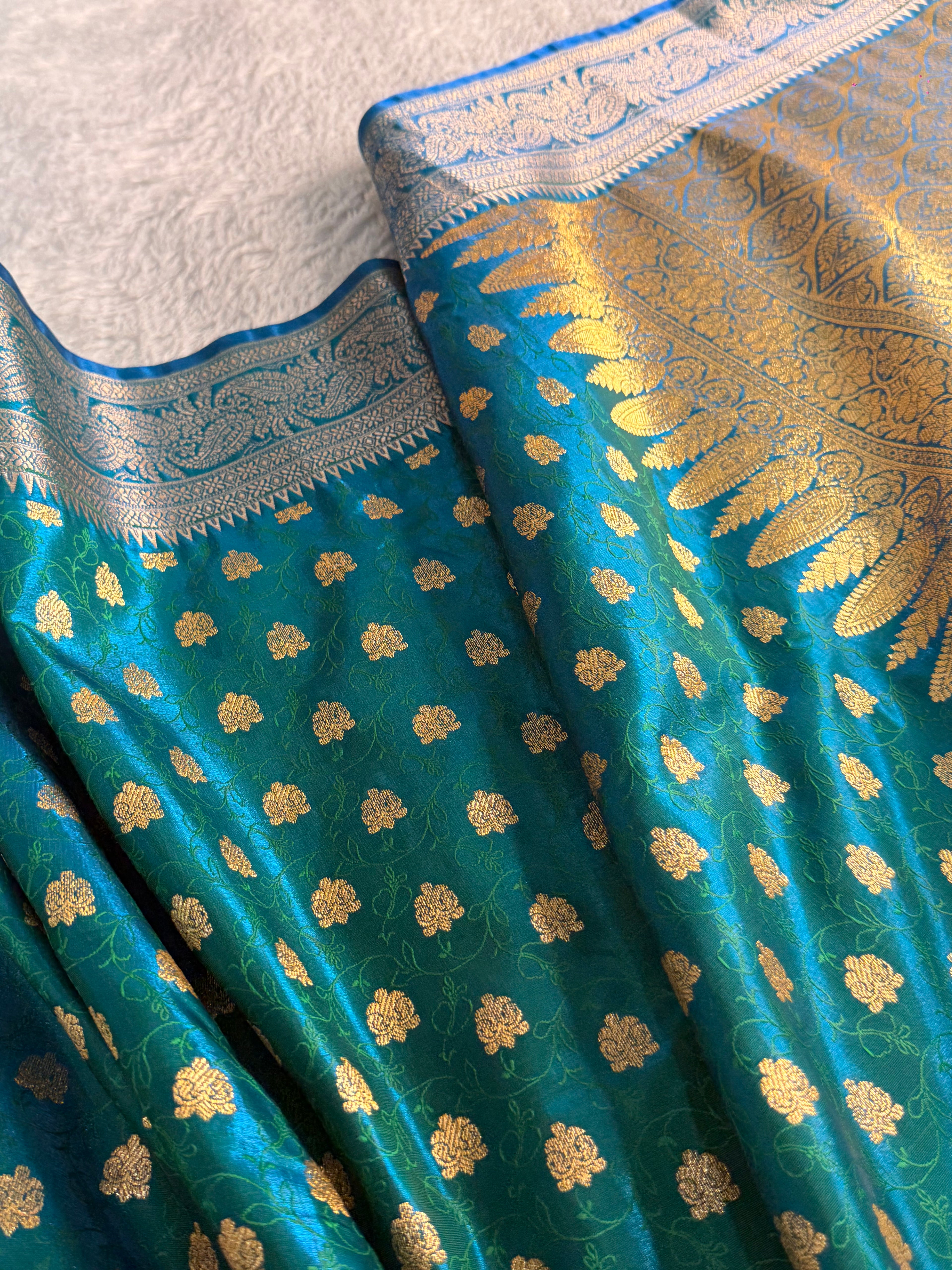 Banarasi satin silk saree in bottle green color with tanchoi design all over the body