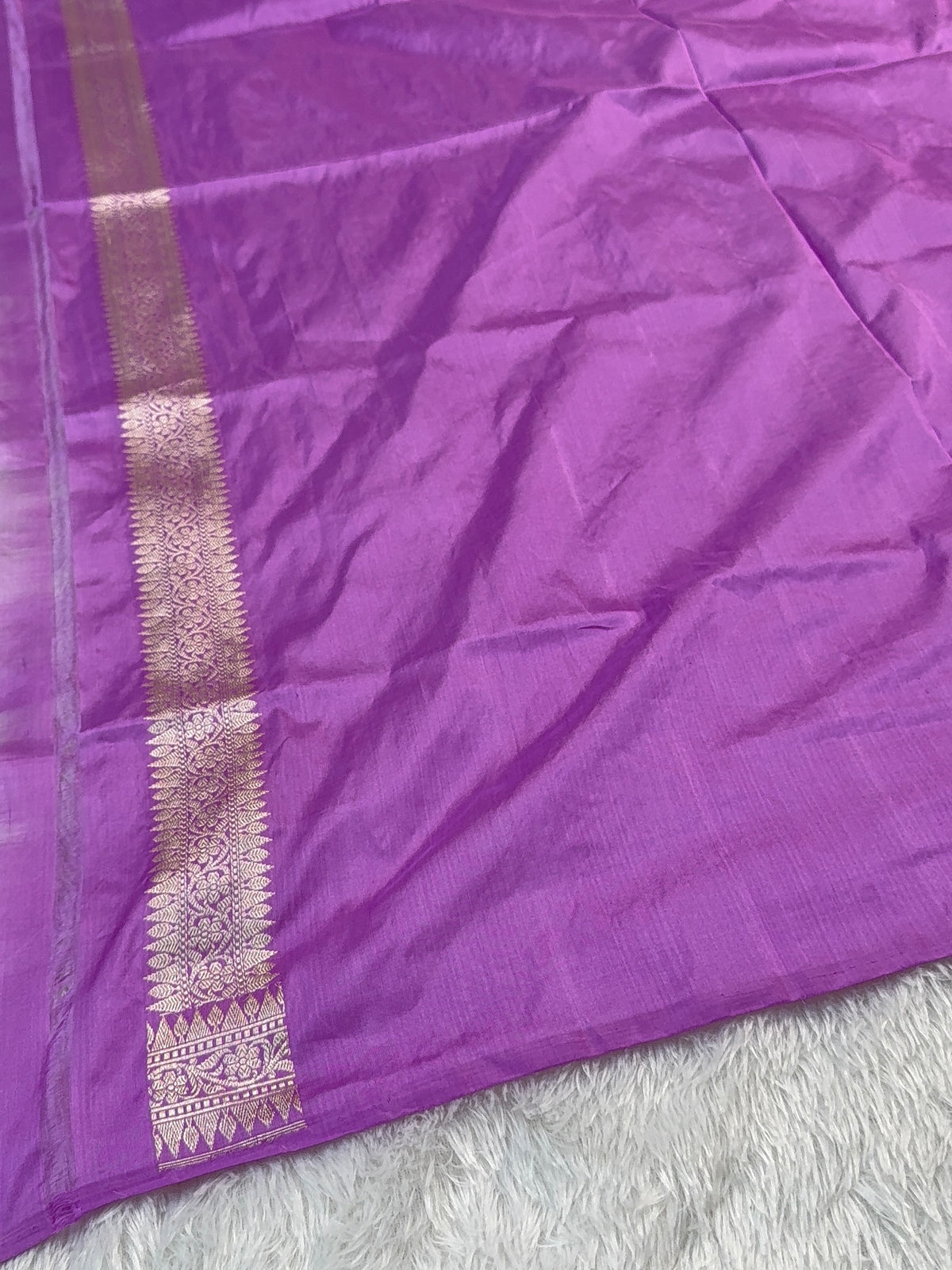 Handwoven pure katan silk saree with interlock weaving motifs and Konia design with intricate silver and gold zari in a light Purple colour