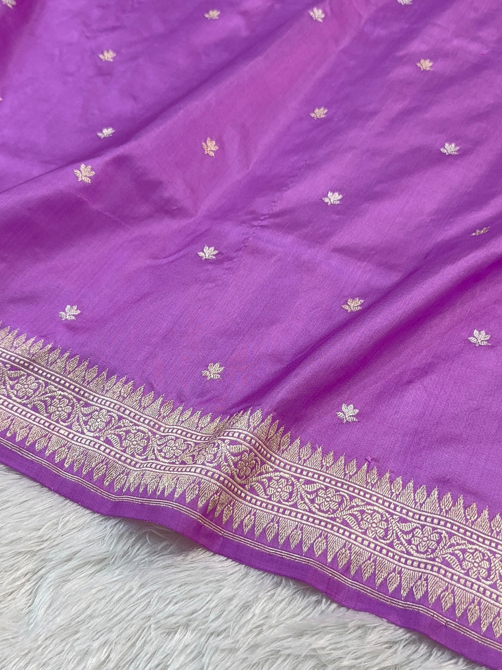 Handwoven pure katan silk saree with interlock weaving motifs and Konia design with intricate silver and gold zari in a light Purple colour