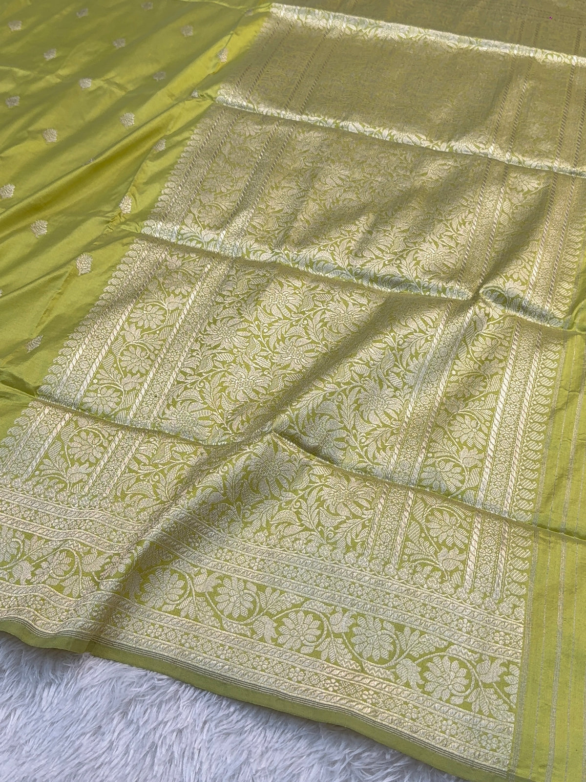 Handwoven pure katan silk saree with interlock weaving motifs with intricate silver zari in Neon Pista colour