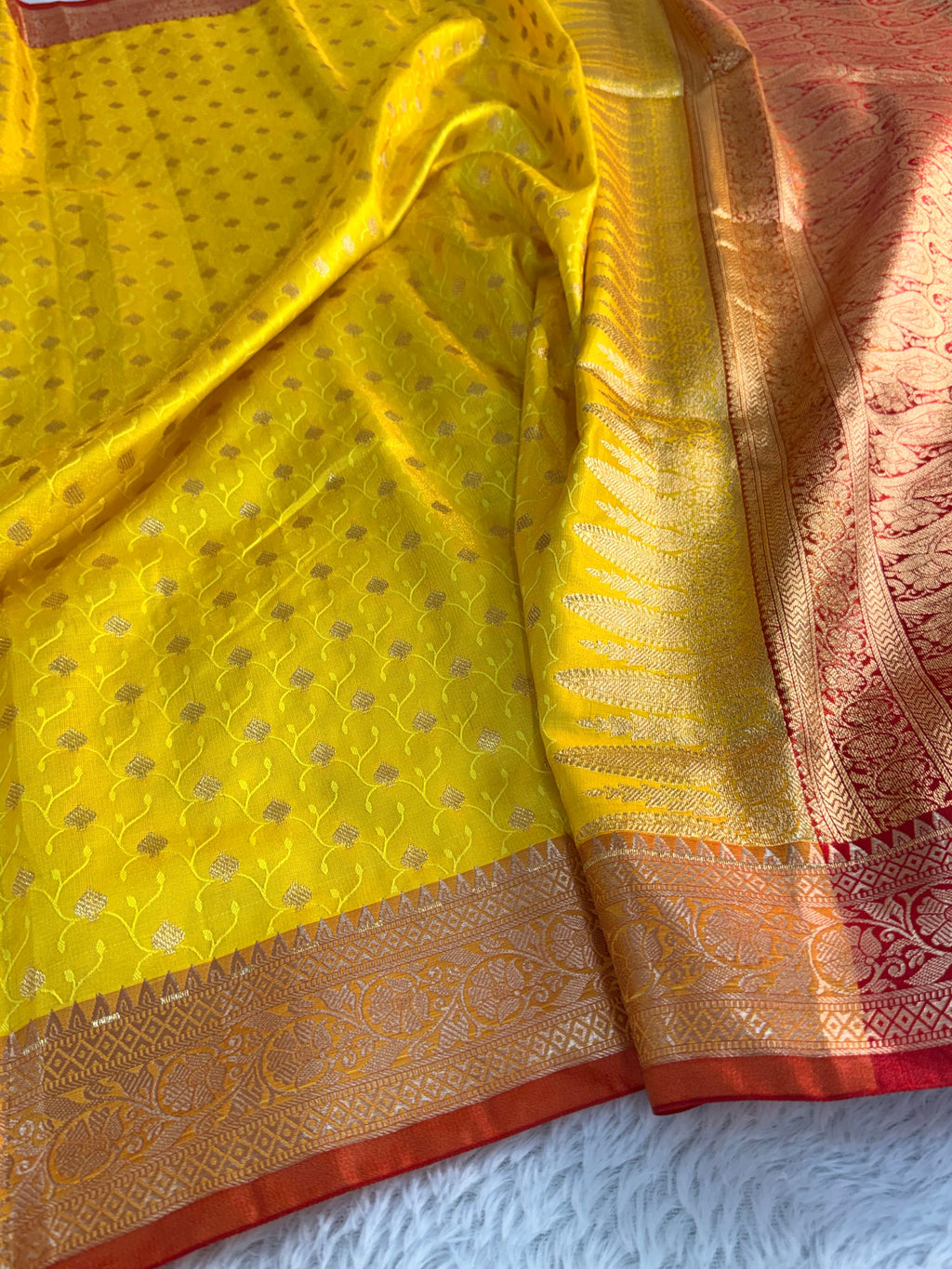 Banarasi satin silk saree in yellow color with tanchoi design all over the body