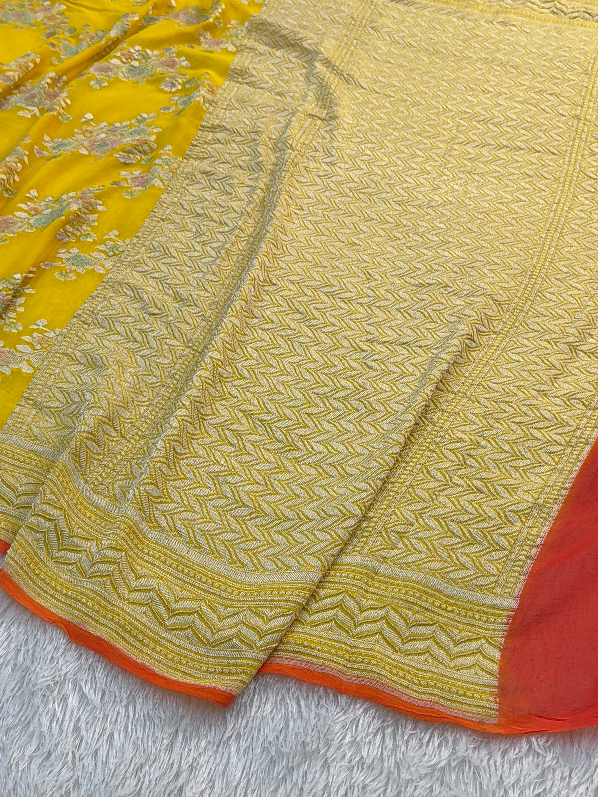 Banarasi Pure Khaddi Chiffon Saree  with Silver Zari Work In Floral Jaal Design with Meenakari by handbrush Yellow Colour with orange edge