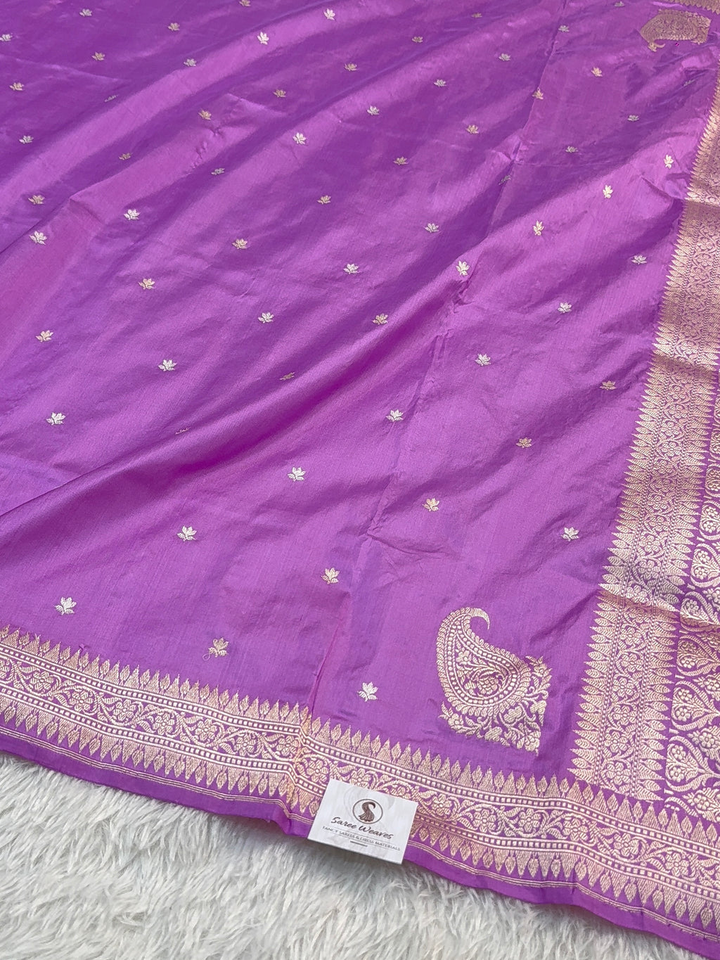 Handwoven pure katan silk saree with interlock weaving motifs and Konia design with intricate silver and gold zari in a light Purple colour
