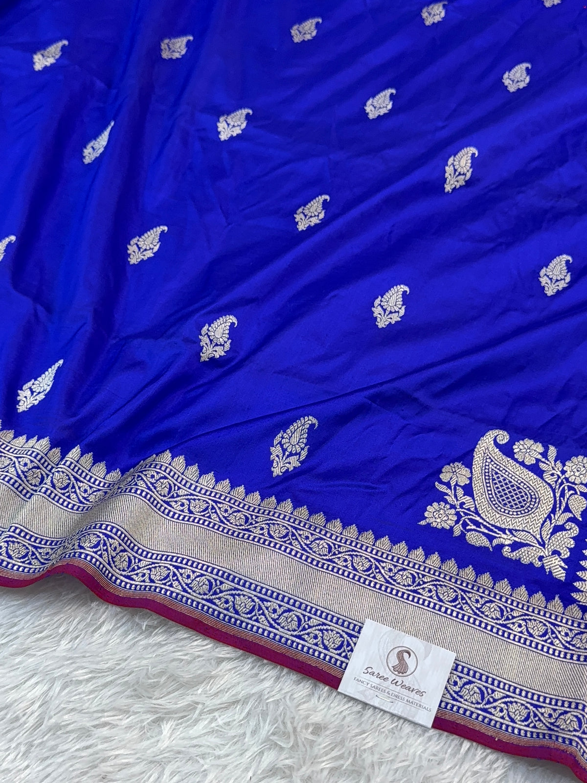 Handwoven pure katan silk saree with interlock weaving motifs in intricate silver and gold zari with Maroon Edge and Konia design in Royal Blue colour