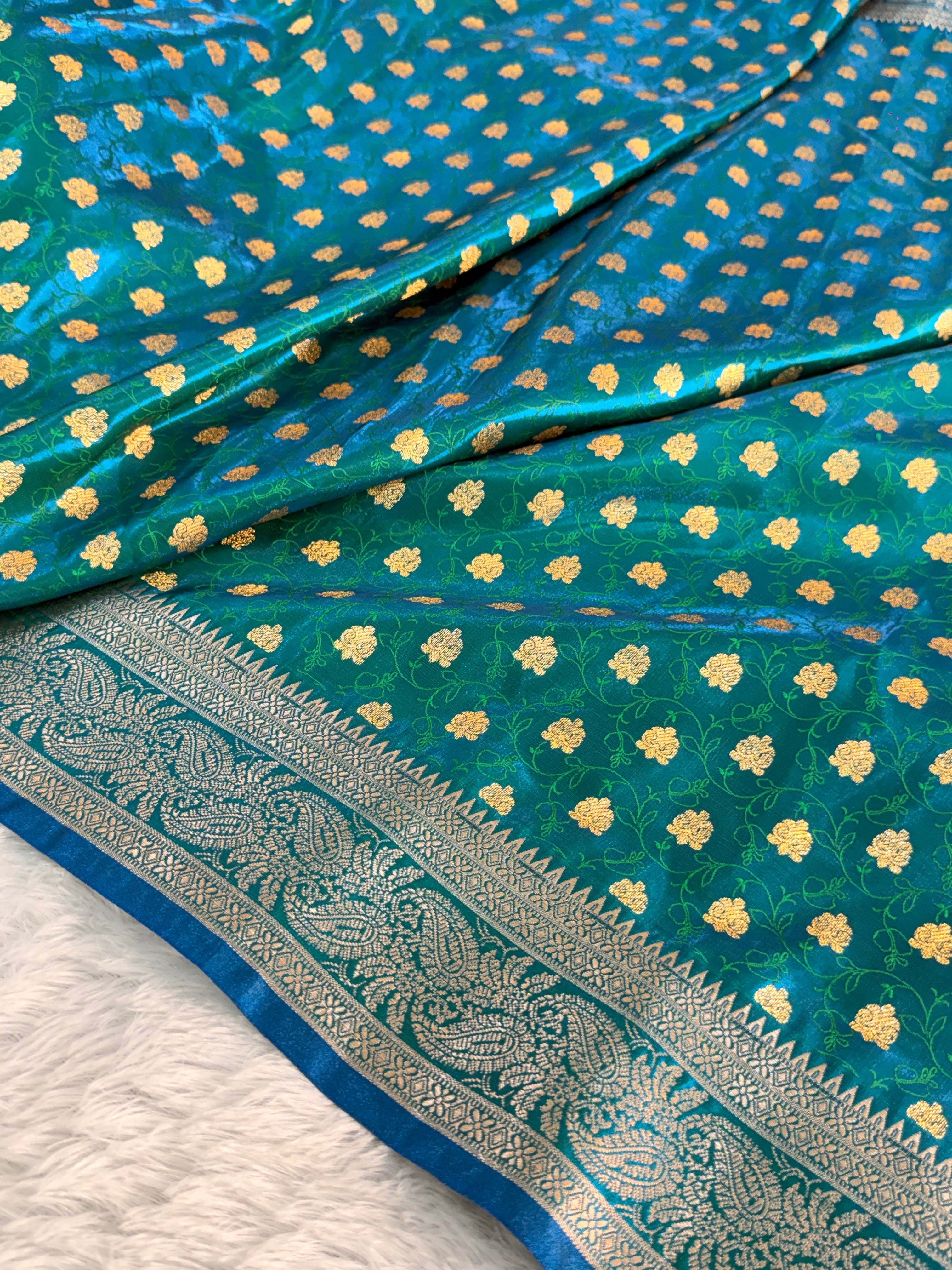 Banarasi satin silk saree in bottle green color with tanchoi design all over the body